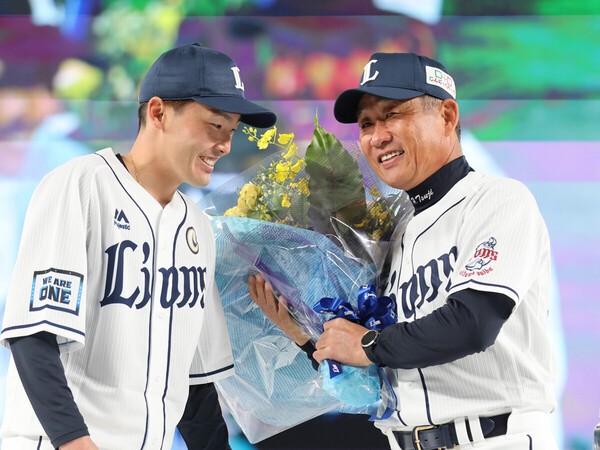 2022年限りで監督を退任し、ファン感謝デーで源田壮亮（左）から花束を贈られた辻発彦氏
